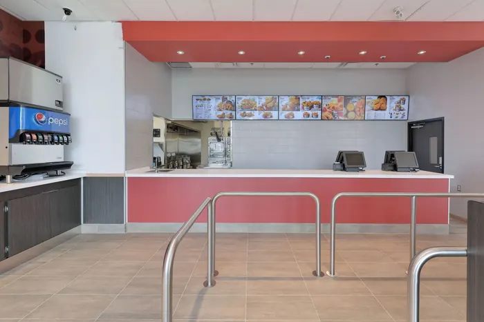 Service counter with the kitchen equipment line behind, KFC, Keswick, Ontario