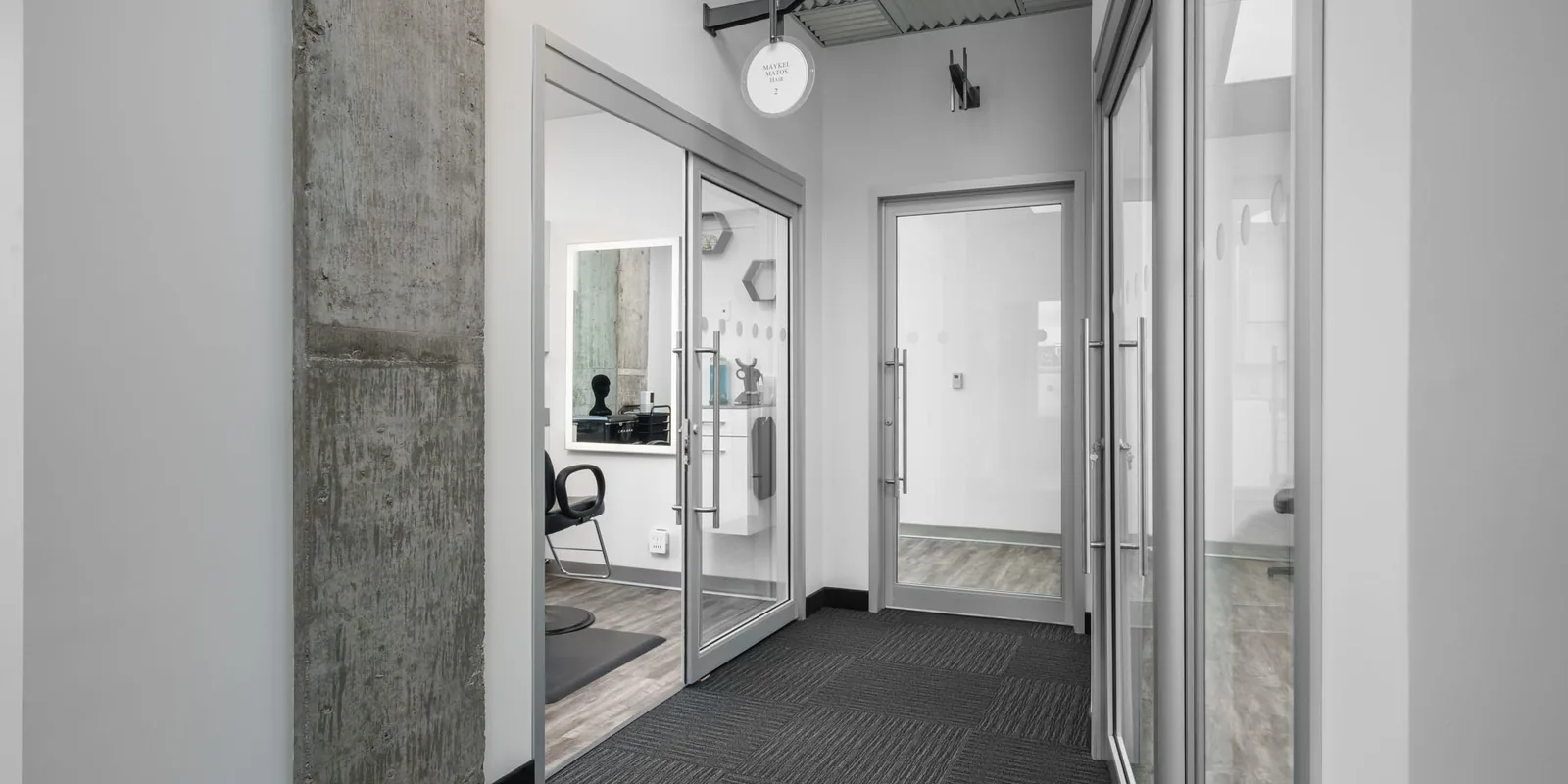 Completed Sola Salon Studios corridor with individually signed studio units, Calgary, Alberta