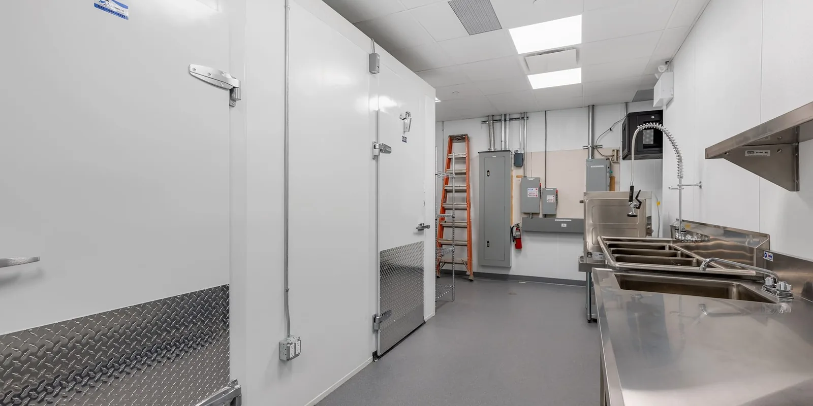 Commercial kitchen back-of-house with walk-in refrigeration, stainless prep line and electrical services, Odd Burger, Whitby, Ontario