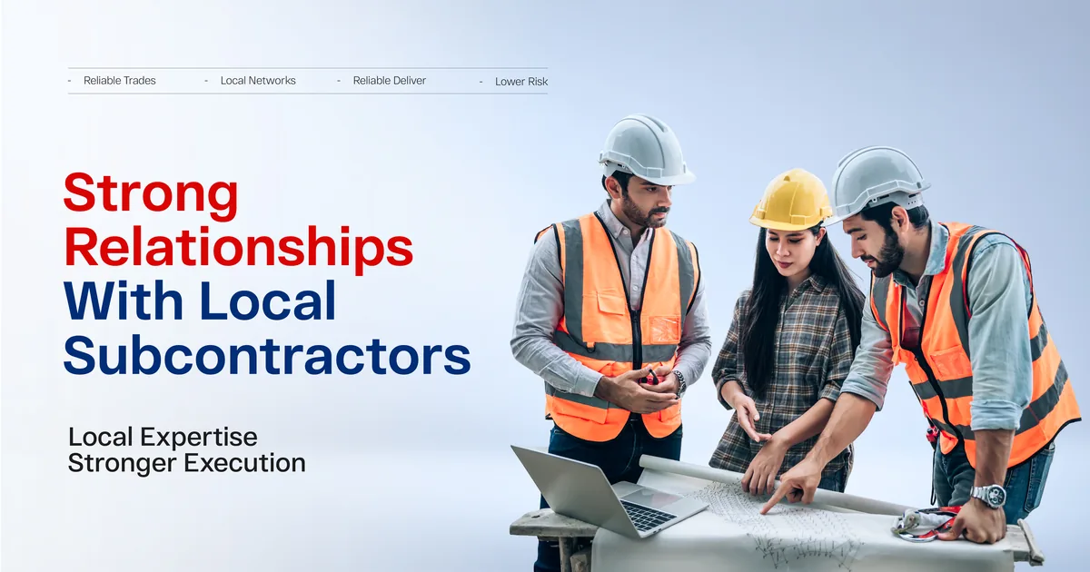 Three workers in hard hats and hi-vis vests reviewing drawings and a laptop on a site table