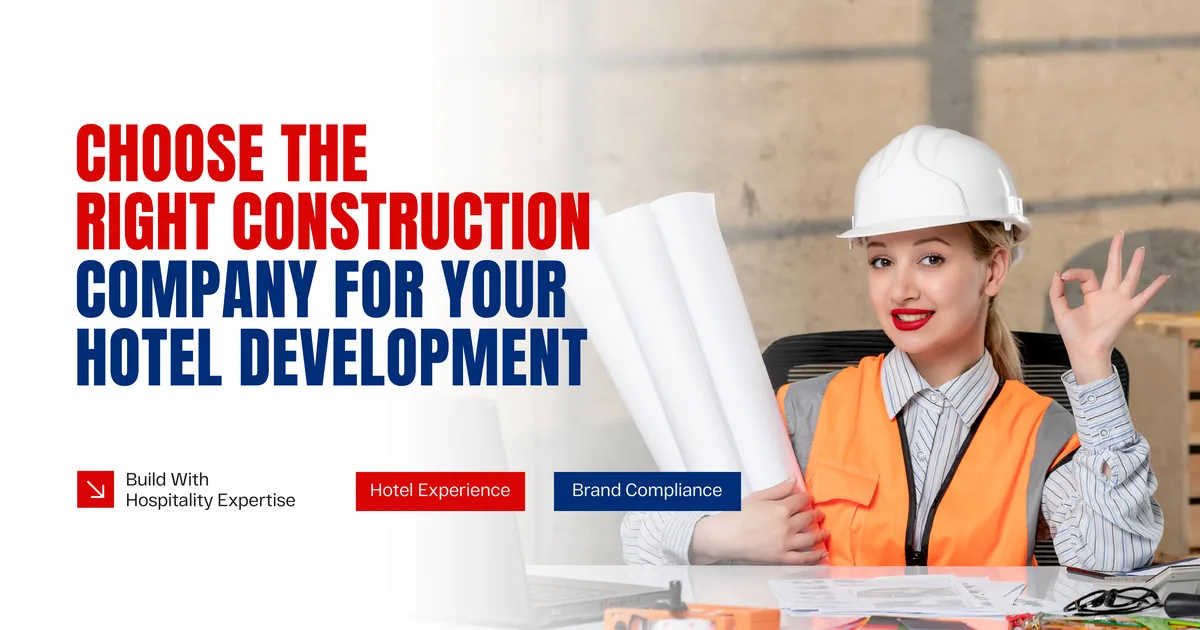 A project manager in a white hard hat and orange vest at a desk, holding rolled drawings and giving an OK hand sign